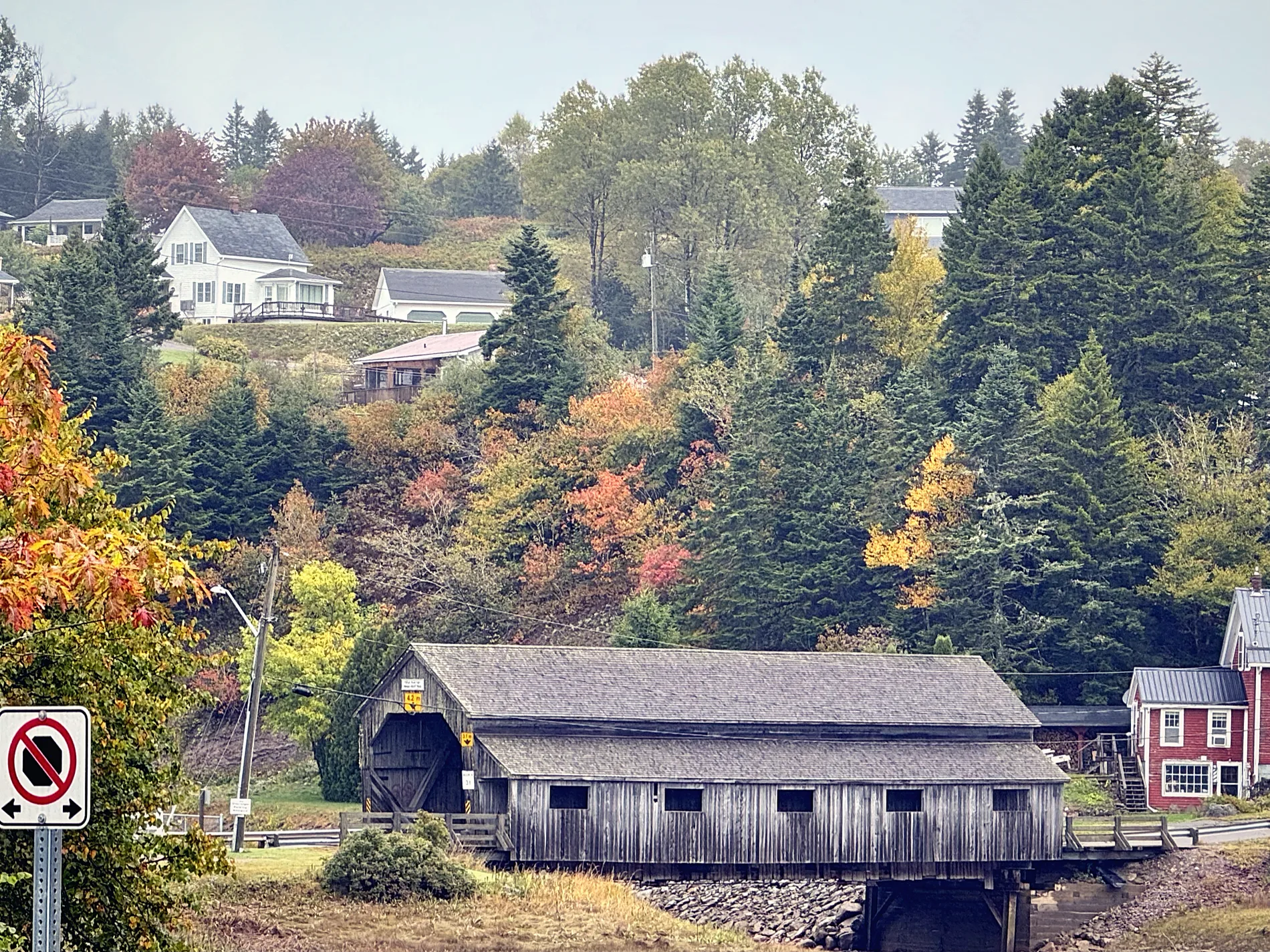 Covered bridge in St. Martins with autumn trees and village houses