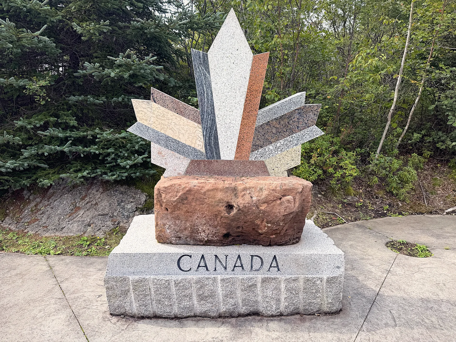 Stone maple leaf monument with the word Canada